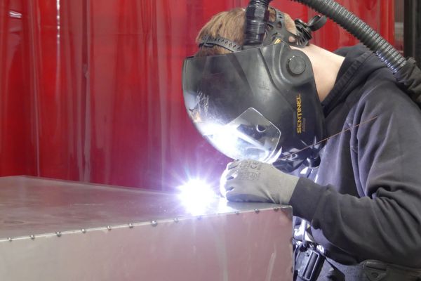 Fe26 Fabrications - photo of a welder at work
